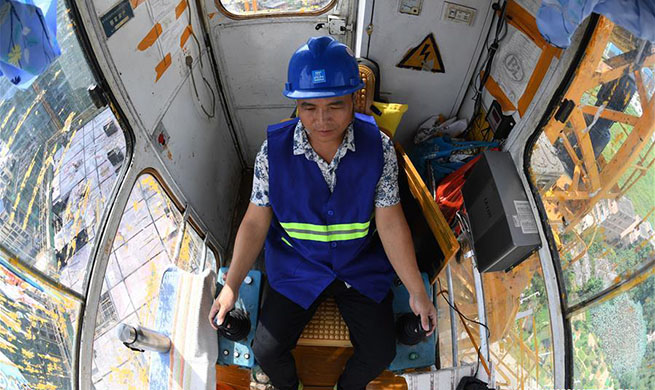 Tower crane operator works in Nanning, south China's Guangxi